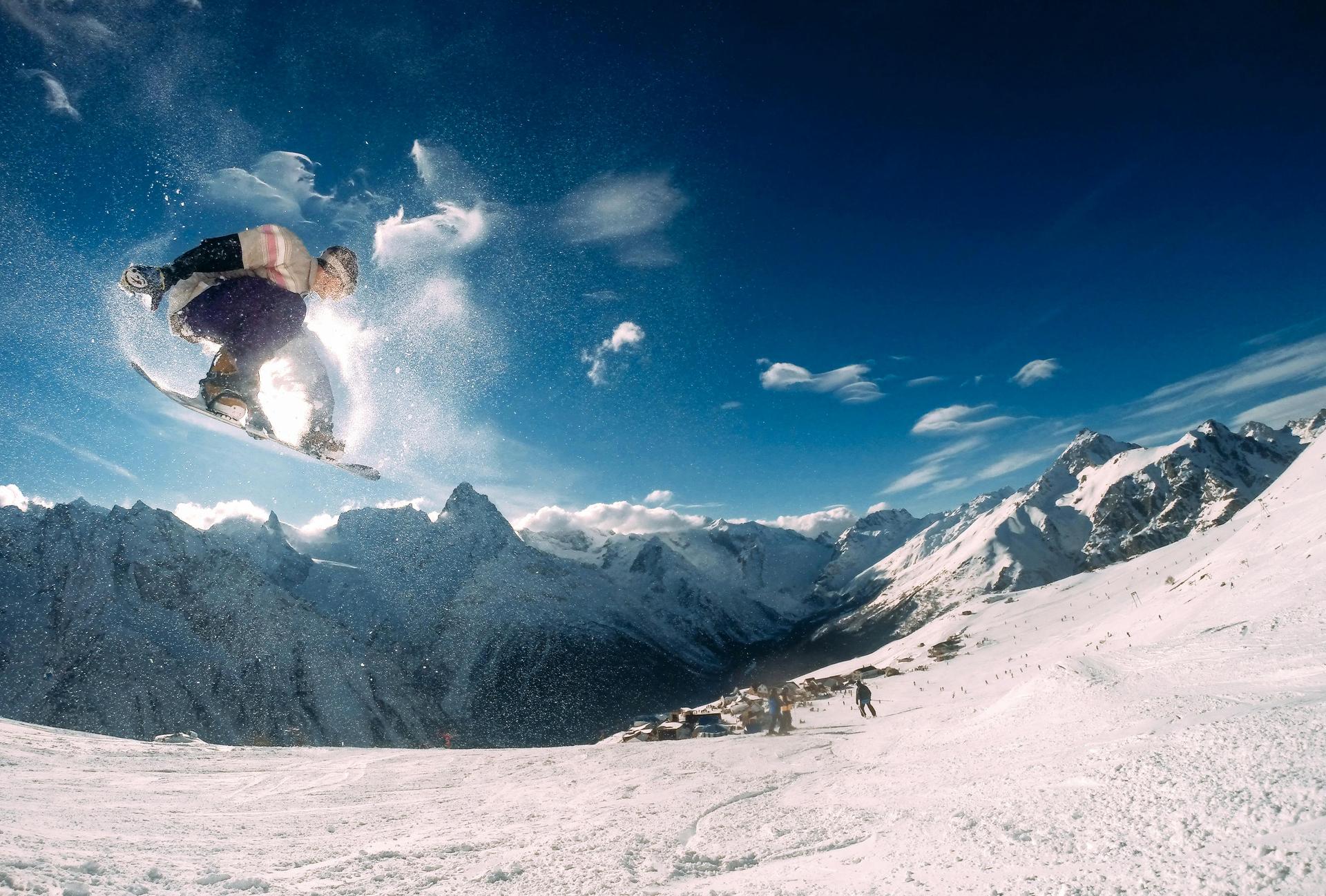 snowboarder-with-skiers-in-the-mountains